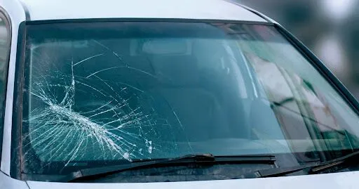Close-up of a severely cracked car windshield needing urgent replacement in Surrey, BC.