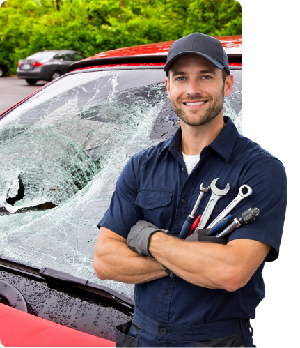 A smiling, professional auto glass repair expert standing in front of a car with a shattered windshield, ready to provide mobile glass replacement in vancouver.