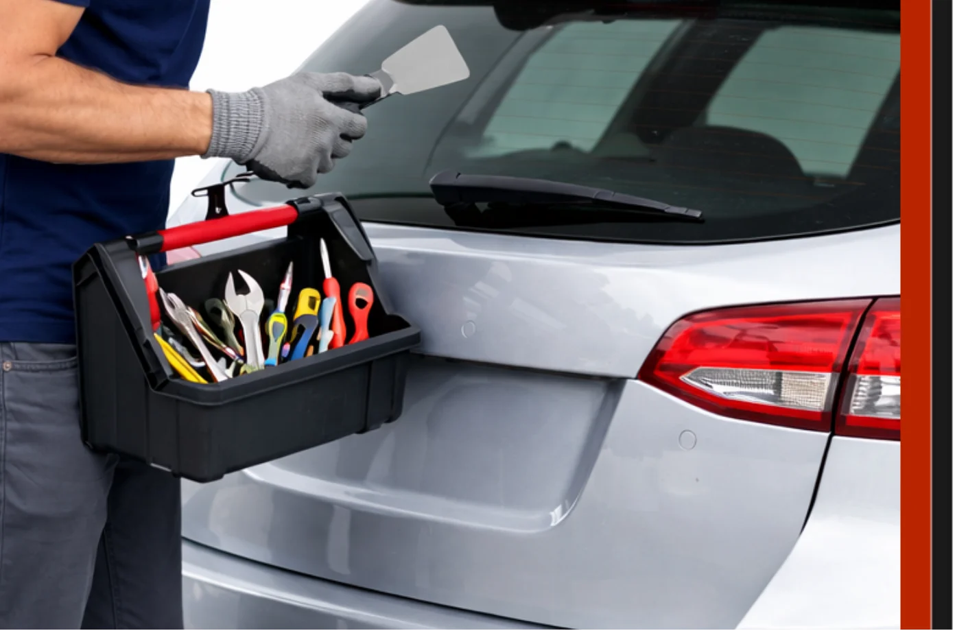 Technician at Expert Auto Glass Surrey using professional tools to replace the rear heated glass on a silver hatchback vehicle.