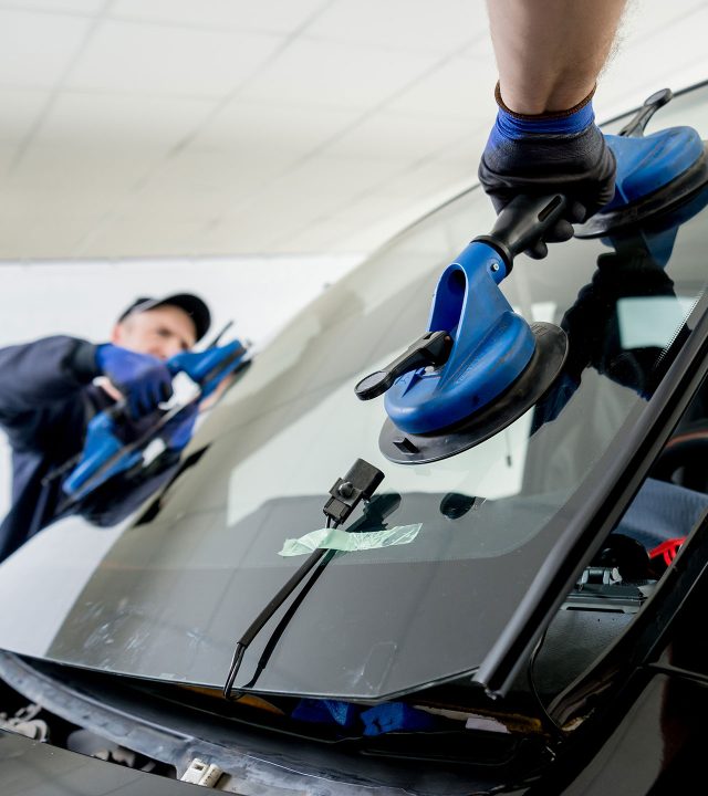 Expert Auto Glass Surrey technician installing new windshield during auto glass repair